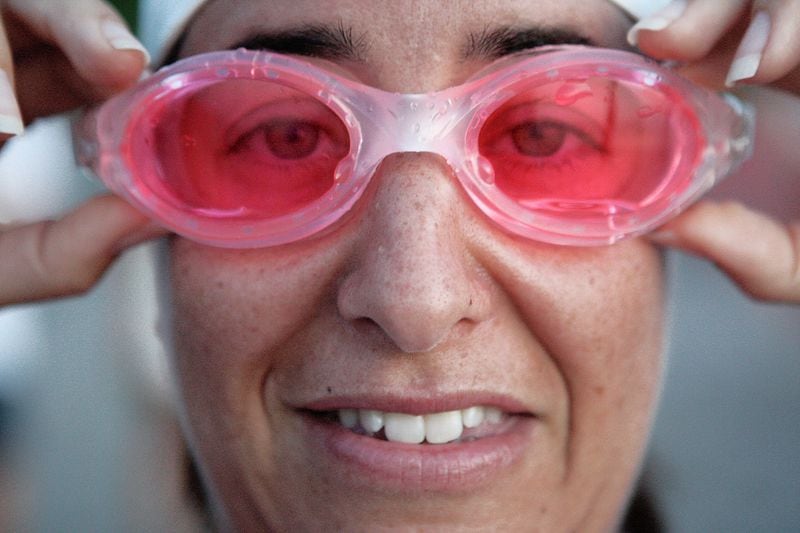 Amy Simpson, 40, of West Palm Beach, adjusts her goggles just prior to the start of the Loggerhead Triathlon held at Carlin Park Saturday morning. The event, which began at 7 a.m., began with a three-eighths of a mile ocean swim, followed by a 13-mile bike ride from Carlin Park to Loggerhead Park, and concluded with a 5k run from Carlin Park to the Jupiter Inlet and back. Photo by Damon Higgins/The Palm Beach Post