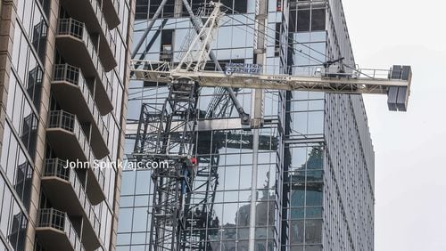 Crews worked all day Friday to stabilize a leaning crane at a 31-story office building in Midtown.