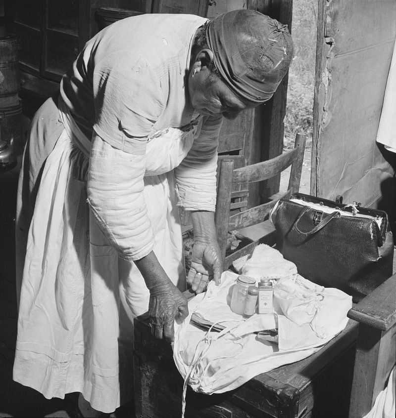 A midwife wraps her kit to go on a call in Greene County, Ga., in October 1941. (Courtesy of Jack Delano / Library of Congress)