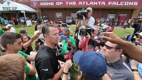 Falcons QB Matt Ryan is surrounded by members of the media during last summer's training camp in Flowery Branch.