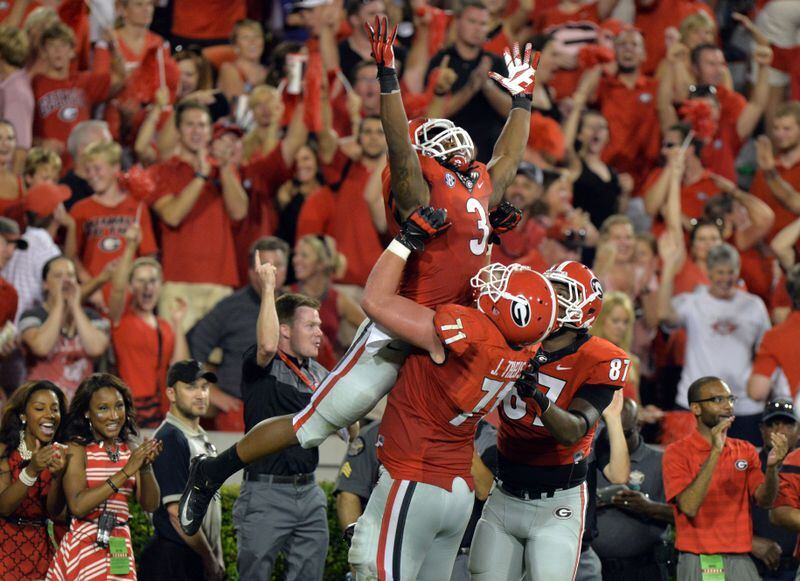 August 30, 2014 Athens, GA: Georgia Bulldogs running back Todd Gurley celebrates a 4th quarter touchdown against Clemson with teammate John Theus Saturday August 30, 2014 in Athens. BRANT SANDERLIN / BSANDERLIN@AJC.COM . Todd Gurley ascendant. (Brant Sanderlin/AJC)