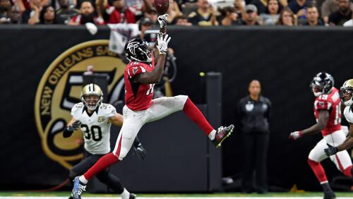 Atlanta Falcons wide receiver Mohamed Sanu (12) leaps for a pass against New Orleans Saints defensive back Erik Harris (30) in the first half in New Orleans, Monday, Sept. 26, 2016.