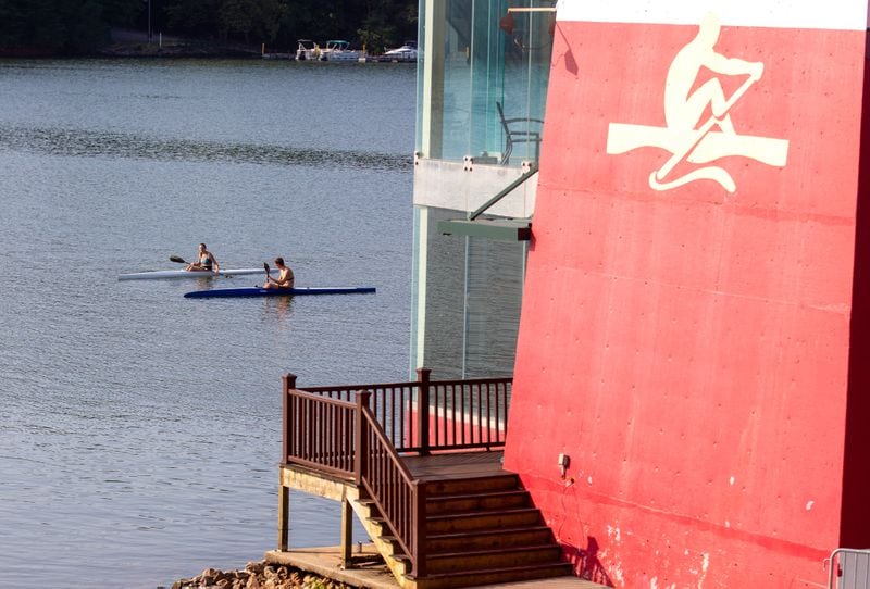 Two people row past the Olympic Tower at Lake Lanier Olympic Park in Gainesville on August 7, 2021. STEVE SCHAEFER FOR THE ATLANTA JOURNAL-CONSTITUTION