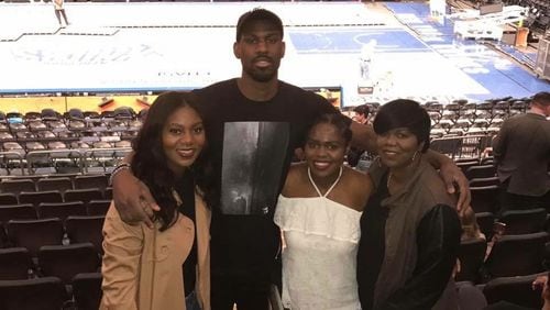 Hawks player Alex Poythress is surround by (from left to right) his twin sister Alexis, sister Alyssa and mother Regina in New York.
