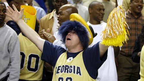 Georgia Tech fan Lyle Judson from Buford celebrates the Yellow Jackets' 83-82 win over North Carolina in the first round of the ACC Tournament in Greensboro, North Carolina,  Friday, March 12, 2004. Jarrett Jack hit a last-second shot to give the Jackets their win over the Tar Heels. (Brant Sanderlin/AJC file)