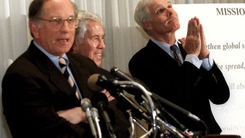 Ted Turner, then a vice-chairman at AOL Time Warner, right, “prays” during a 2001 press conference at the National Press Club in Washington that launched the Nuclear Threat Initiative with former Georgia Sen. Sam Nunn, left. AP /Michael DiBari Jr.