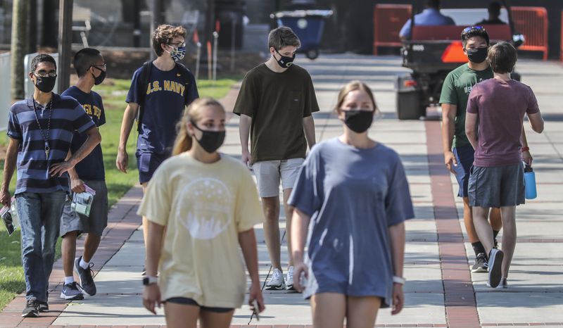 Georgia Tech students masked up and enjoyed a warm day near the Albert Einstein monument on the Georgia Tech campus on Monday, August 10, 2020, the first full day of the semester. JOHN SPINK/JSPINK@AJC.COM


