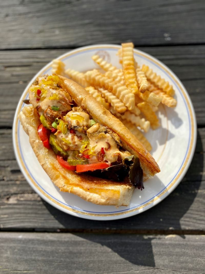Grass VBQ Joint’s oyster po'boy is made with cornmeal-crusted blue oyster mushrooms, and is dressed like the classic Louisiana sandwich. Wendell Brock for The Atlanta Journal Constitution