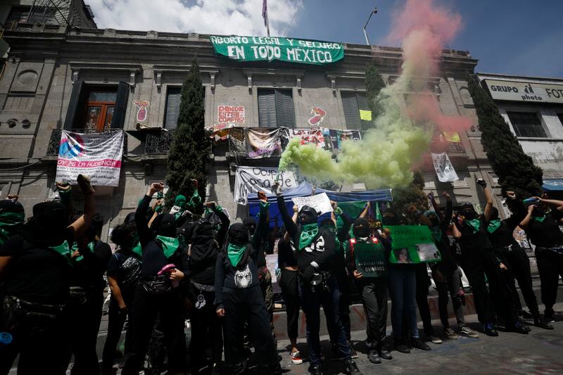 Feminist anarchist protesters chant in front of the offices of the governmental Human Rights Commission, which they occupied, during an action in support of abortion rights in central Mexico City in September 2020. (AP Photo/Rebecca Blackwell)