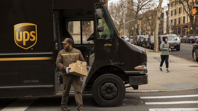 FILE -- A UPS driver makes the rounds in Brooklyn's Park Slope neighborhood, March 18, 2020. (Benjamin Norman/The New York Times)