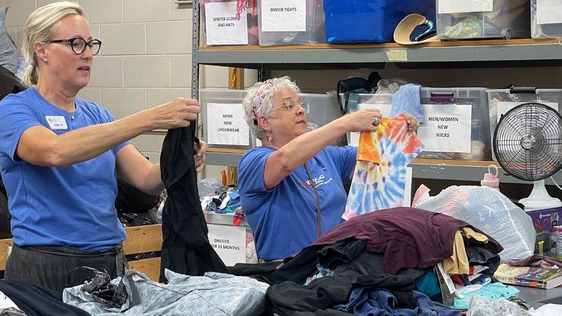 Volunteers at North Fulton Community Charities sort clothing donated to the thrift shop. Revenue from the thrift shop directly supports programs and services in the community. COURTESY NORTH FULTON COMMUNITY CHARITIES