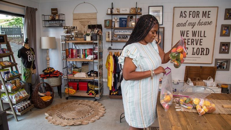 LaTonya Gates works in the PAWkids food pantry and store located in Claudia's House, named after her grandmother.  PHIL SKINNER FOR THE ATLANTA JOURNAL-CONSTITUTION.