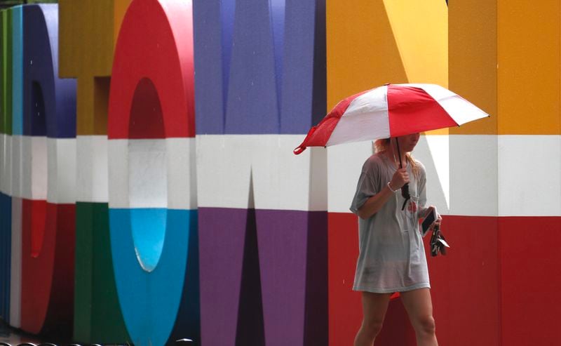 Midtown saw nearly constant rain showers Wednesday morning.  BOB ANDRES / BANDRES@AJC.COM