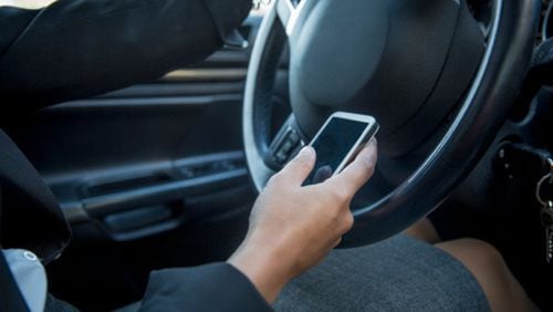 In December or January, a decision may be made by the Smyrna City Council on whether to prohibit the use of handheld cell phones or other electronic devices while driving. AJC file photo