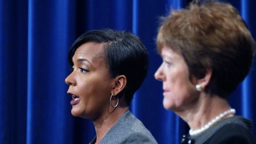 Atlanta mayoral candidate Keisha Lance Bottoms speaks as her opponent Mary Norwood looks on during a recent debate. The candidates will square off in the Dec. 5 runoff election. HYOSUB SHIN / HSHIN@AJC.COM