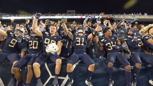 Georgia Tech players celebrate their victory over North Carolina State during an NCAA college football game at Bobby Dodd Stadium on Thursday, November 21, 2019. Georgia Tech won 28-26. (Hyosub Shin / Hyosub.Shin@ajc.com)