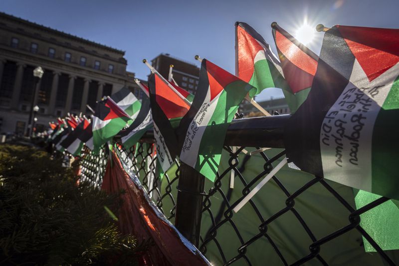 A row of Palestinian flags are seen on the fence at the pro-Palestinians demonstration encampment at Columbia University in New York on Wednesday April 24, 2024. (AP Photo/Stefan Jeremiah)
