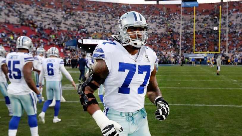 In this file photo, Dallas Cowboys offensive tackle Tyron Smith (77) jogs out for warmups before their NFC Divisional Playoff game against the Los Angeles Rams at Los Angeles Memorial Coliseum in Los Angeles, Saturday, January 12, 2019.  The Cowboys don't sound optimistic about Smith's availability for Sunday's game against the Atlanta Falcons after he suffered a neck injury going through individual drills and didn't practice on Thursday or Friday. (Tom Fox/Dallas Morning News/TNS)