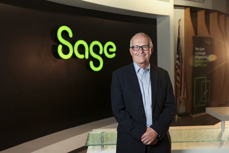 Sage CEO Steve Hare poses for a portrait in the lobby at Sage’s North America headquarters, Tuesday, April 23, 2024, in Lawrenceville, Ga. Sage, a publicly traded accounting, financial, HR, and payroll technology company whose North America headquarters is  in metro Atlanta, announced an expansion of its partnership with Morehouse College. (Jason Getz / AJC)
