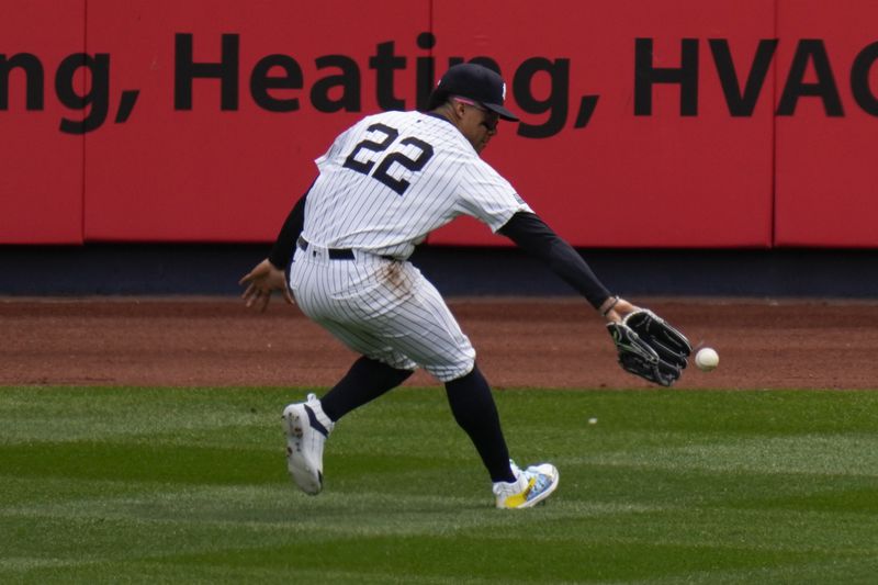 New York Yankees outfielder Juan Soto can't get his glove on a ball hit by Toronto Blue Jays' George Springer during first inning of a home-opener baseball game at Yankee Stadium Friday, April 5, 2024, in New York. (AP Photo/Seth Wenig)