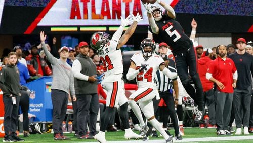 Atlanta Falcons wide receiver Drake London (5) goes up for an impressive reception during the fourth quarter against the Tampa Bay Buccaneers on Sunday, Dec. 10, 2023,  at Mercedes-Benz Stadium in Atlanta. Miguel Martinez/miguel.martinezjimenez@ajc.com