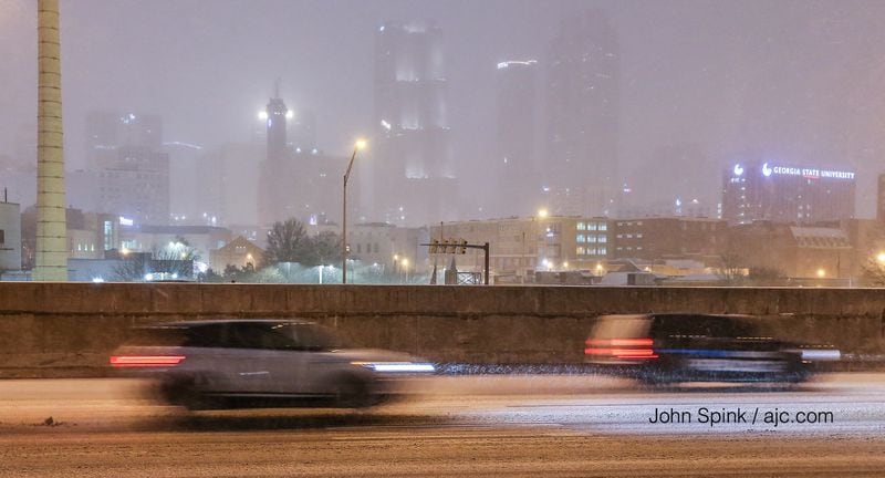 A thin layer of snow covers the Downtown Connector in Atlanta. JOHN SPINK / JSPINK@AJC.COM