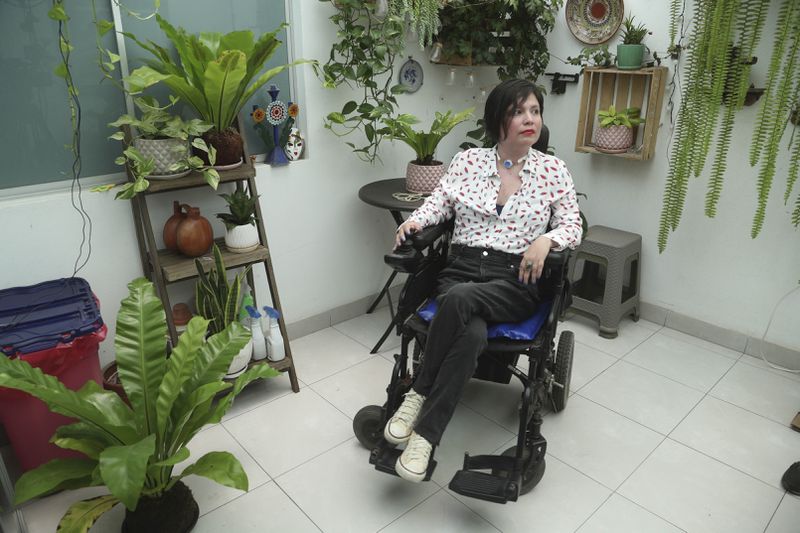 FILE - Ana Estrada, a Peruvian psychologist, sits inside her home in Lima, Peru, Dec. 18, 2019. Estrada, who suffered from an incurable disease and was authorized in 2022 by Peru's Supreme Court to receive euthanasia, has died, her lawyer said Monday, April 22, 2024. (AP Photo/Martin Mejia, File)