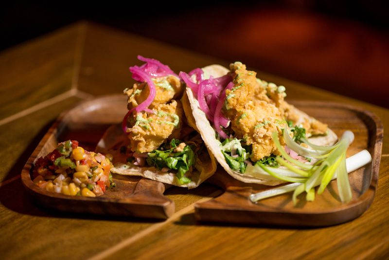 Tiki Tango Tacos are corn torillas filled with coconut and panko-crusted shrimp topped with sesame slaw and a cucumber wasabi aoli. Photo credit- Mia Yakel.