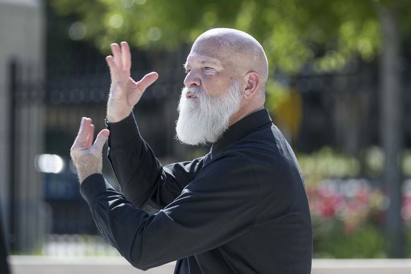 David Cowan, an American Sign language deaf interpreter with All Hands On, interprets remarks made by Gov. Brian Kemp during a press conference at Liberty Plaza, across the street from the Capitol building in Atlanta, on April 20, 2020. 