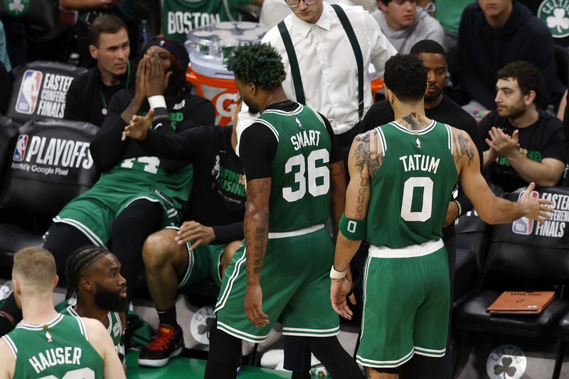 Boston Celtics guard Marcus Smart (36) and forward Jayson Tatum (0) walks to the bench after being taken out of the game during the second half in Game 7 of the NBA basketball Eastern Conference finals against the Miami Heat Monday, May 29, 2023, in Boston. (AP Photo/Michael Dwyer)