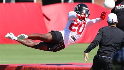 Falcons cornerback Kendall Sheffield stretches out to block a soccer ball while running an agility drill during the third practice of training camp Wednesday, July 24, 2019, in Flowery Branch.