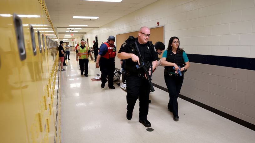 The Cherokee County Sheriff’s Office conducts a training exercise at Mill Creek Middle School in Woodstock on June 8, 2022. The training exercise was an active shooter drill to prepare officers to respond to school shootings. The Georgia Senate passed a bill Monday aimed at improving active shooter drills. (Jason Getz / Jason.Getz@ajc.com)
