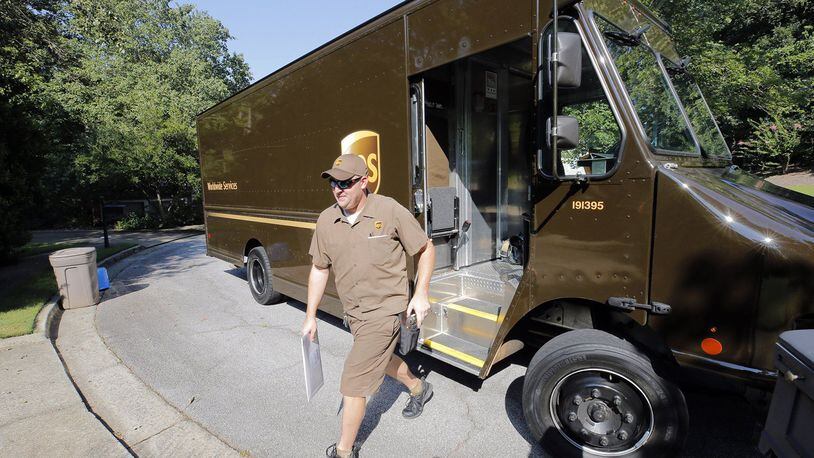 Driver Dan Partyka delivers an overnight package last year. As more people buy more goods online, the rapid and unrelenting expansion of e-commerce is causing real challenges for UPS.  (Bob Andres/Atlanta Journal-Constitution/TNS)
