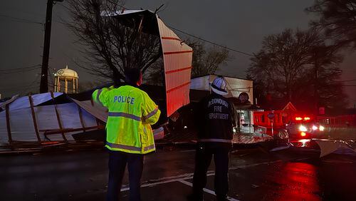 Emergency officials survey the storm damage in the McDonough square after powerful storms swept through Georgia on Thursday.