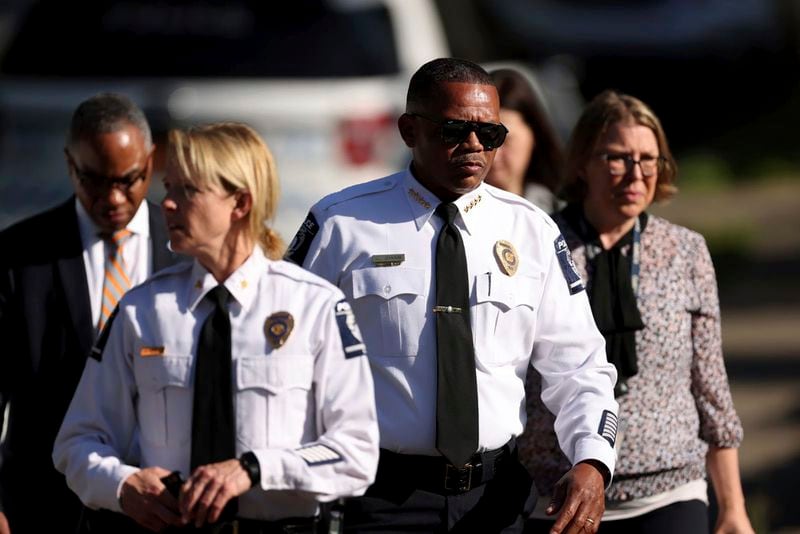 Charlotte Mecklenburg Police Chief Johnny Jennings, center, leaves the scene where multiple law enforcement officers were shot on Galway Drive in Charlotte, N.C. on Monday, April 29, 2024. Several officers on a U.S. Marshals Task Force serving a warrant for a felon wanted for possessing a firearm were killed and other officers were wounded in a shootout Monday in a North Carolina, home, police said. (Khadejeh Nikouyeh/The Charlotte Observer via AP)