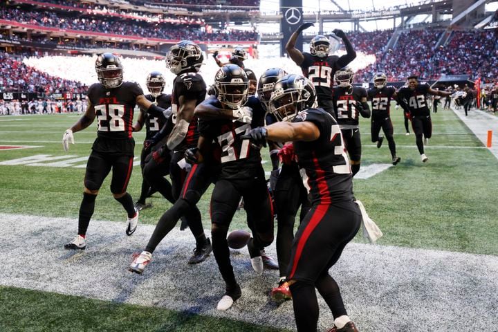 Falcons players gather in the end zone after an interception by Dee Alford (37) on Sunday in Atlanta. (Miguel Martinez / miguel.martinezjimenez@ajc.com)