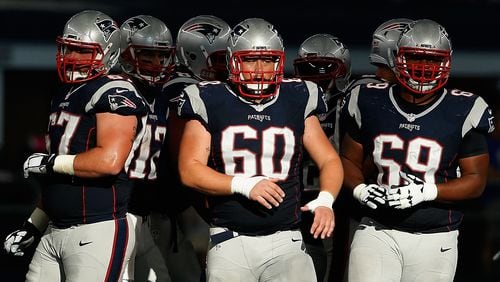 Patriots center David Andrews (60) and guard Shaq Mason (69) are side by side, ready in this case for a second half against Dallas last season. (Christian Petersen/Getty Images)