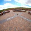 In this photo taken with a fisheye lens, people visit the Columbine Memorial, April 17, 2024, in Littleton, Colo. The 12 students and a teacher killed in the Columbine High School shooting will be remembered Friday, April 19, 2024, in a vigil on the eve of the 25th anniversary of the tragedy. (AP Photo/David Zalubowski, File)