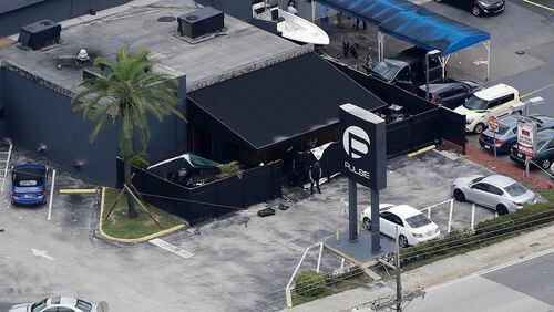 FILE - In this June 12, 2016 file photo, law enforcement officials work at the Pulse gay nightclub in Orlando, Fla., following a mass shooting. A California judge is deciding whether to release the widow of the gunman, Omar Mateen, who killed dozens of people at the Florida nightclub and is accused of helping him. A hearing is set in federal court in Oakland, Calif., on Wednesday, March 1, 2017, to determine whether Noor Salman must stay behind bars while she awaits trial. (AP Photo/Chris O'Meara, File)