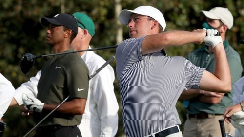 Georgia Tech alum Andy Ogletree hits on the 8th hole next to Tiger Woods during the first round of the Masters in Nov. 2020 at Augusta National. (Curtis Compton / Curtis.Compton@ajc.com)