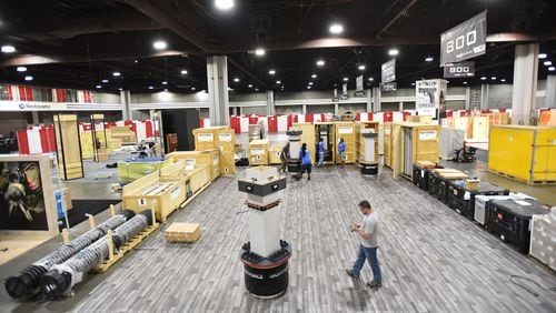 Workers put the finishing touches on the convention floor at the Georgia World Congress Center in preparation for The 146th NRA Annual Meetings and Exhibits in Atlanta. More than 80,000 people are set to attend the NRA convention, which kicks off in Atlanta on Thursday evening and continues through Sunday. HYOSUB SHIN / HSHIN@AJC.COM