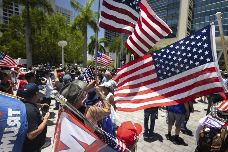 
                        Supporters of former President Donald Trump gather outside the Wilkie D. Ferguson Jr. U.S. Courthouse in Miami, June 13, 2023. Donald J. Trump is set to become the first former president to be arraigned on federal charges when he appears in a Miami courtroom on Tuesday to face charges that he illegally retained national security documents after leaving office, obstructed efforts to retrieve them and made false statements about the matter. (Christian Monterrosa/The New York Times)
                      