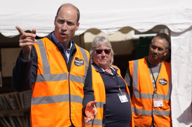 Britain's Prince William talks to van drivers during a visit to Surplus to Supper, in Sunbury-on-Thames, Surrey, England, Thursday, April 18, 2024. The Prince visited Surplus to Supper, a surplus food redistribution charity, to learn about its work bridging the gap between food waste and food poverty across Surrey and West London. (AP Photo/Alastair Grant, pool)