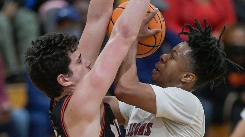 Pebblebrook’s Danny Stubbs (right) attempts a shot against North Gwinnett’s Armon Poyan (left) during their Class 7A state quarterfinal game Wednesday, March 3, 2021, at Pebblebrook High School in Mableton. (Daniel Varnado/For the AJC)