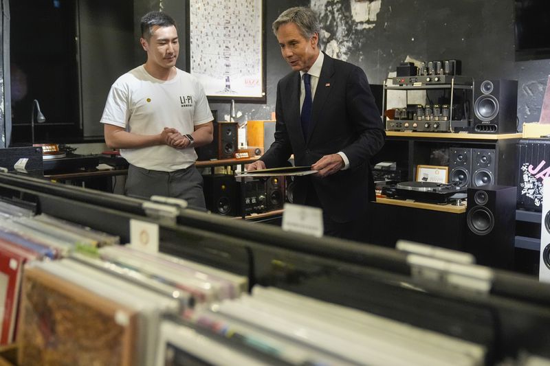 U.S. Secretary of State Antony Blinken talks with Yuxuan Zhou during a visit to Li-Pi record record store in Beijing, China, Friday, April 26, 2024. (AP Photo/Mark Schiefelbein, Pool)