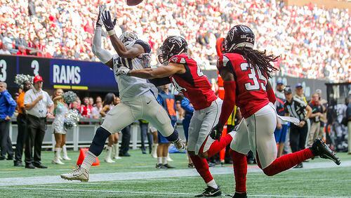 Falcons safety Jamal Carter (35) gives chase as Rams running back Todd Gurley II (30) completes a catch for a touchdown during the first half Sunday, Oct. 20, 2019, at Mercedes-Benz Stadium in Atlanta.