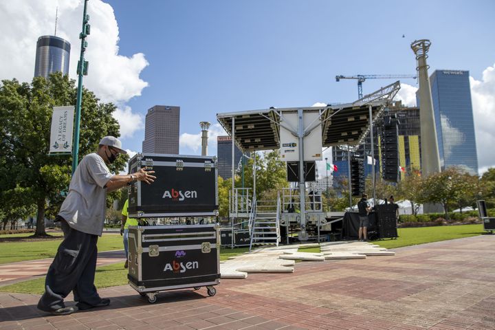 10/22/2020 - Atlanta, Georgia - Bryan Chenault moves equipment near a stage as work is underway to set-up for the ÒBig Night OutÓ concert series at Centennial Olympic Park in downtown Atlanta, Thursday, October 22, 2020. Rival Entertainment is presenting the series in coordination with the Georgia World Congress Center Authority and will offer Atlanta fans an experience with private pods. The ÒBig Night OutÓ will commandeer the downtown park with shows by Moon Taxi and Pigeons Playing Ping Pong (Oct. 23), Marcus King Trio and Futurebirds (Oct. 24) and Big Boi and Friends featuring KP the Great (Oct. 25). (Alyssa Pointer / Alyssa.Pointer@ajc.com)