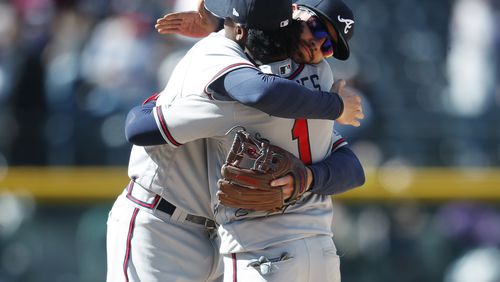 Braves shortstop Dansby Swanson and second baseman Ozzie Albies hug after a recnt win. (AP Photo/David Zalubowski)