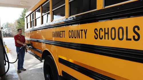 Michael Mueller, Gwinnett County Public Schools Transportation, fills a bus with fuel on Friday, December 7, 2012.   FILE PHOTO