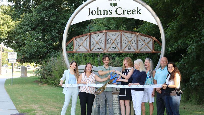Representatives from the Johns Creek Convention and Visitors Bureau and artist William Massey (3rd from left) recently unveiled the city’s second gateway marker on State Bridge Road on the west side of the Chattahoochee River. (Courtesy City of Johns Creek)